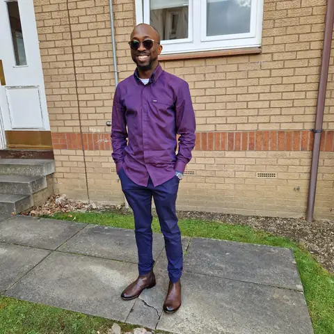 Oluseyi in a purple two-piece, sunglasses on